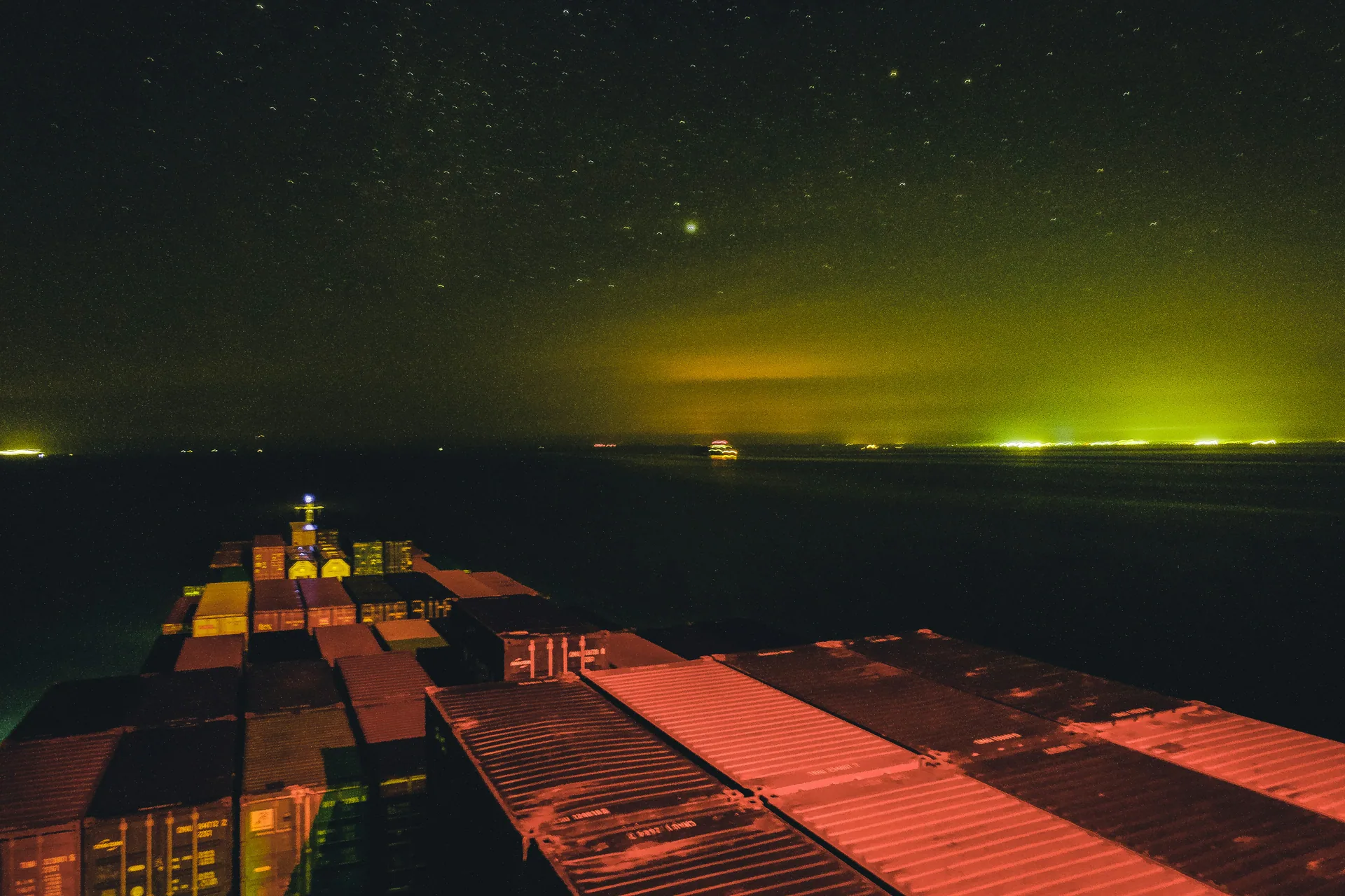 Commercial ships alongside container terminals at dusk