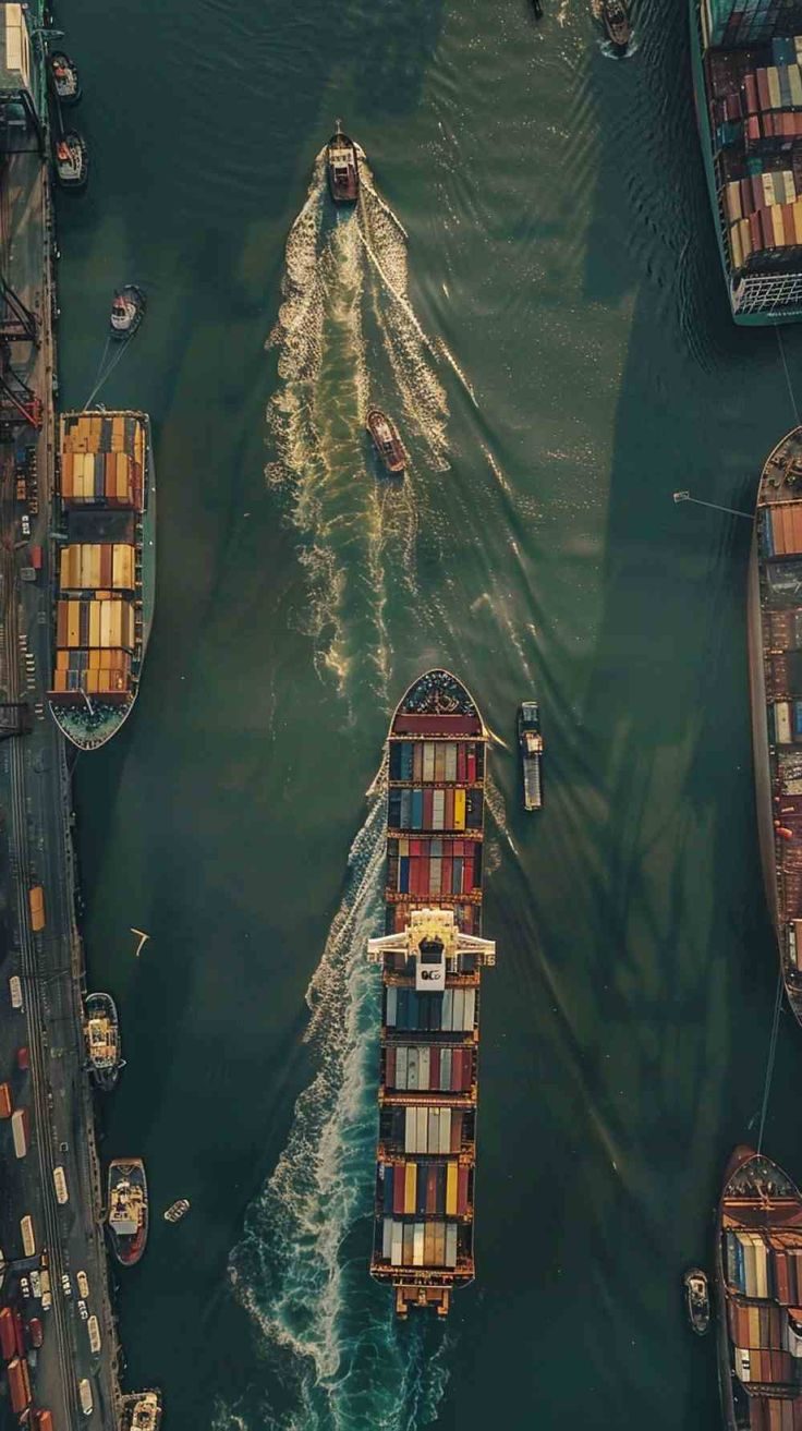 Aerial view of container ships and tugs in a busy port channel