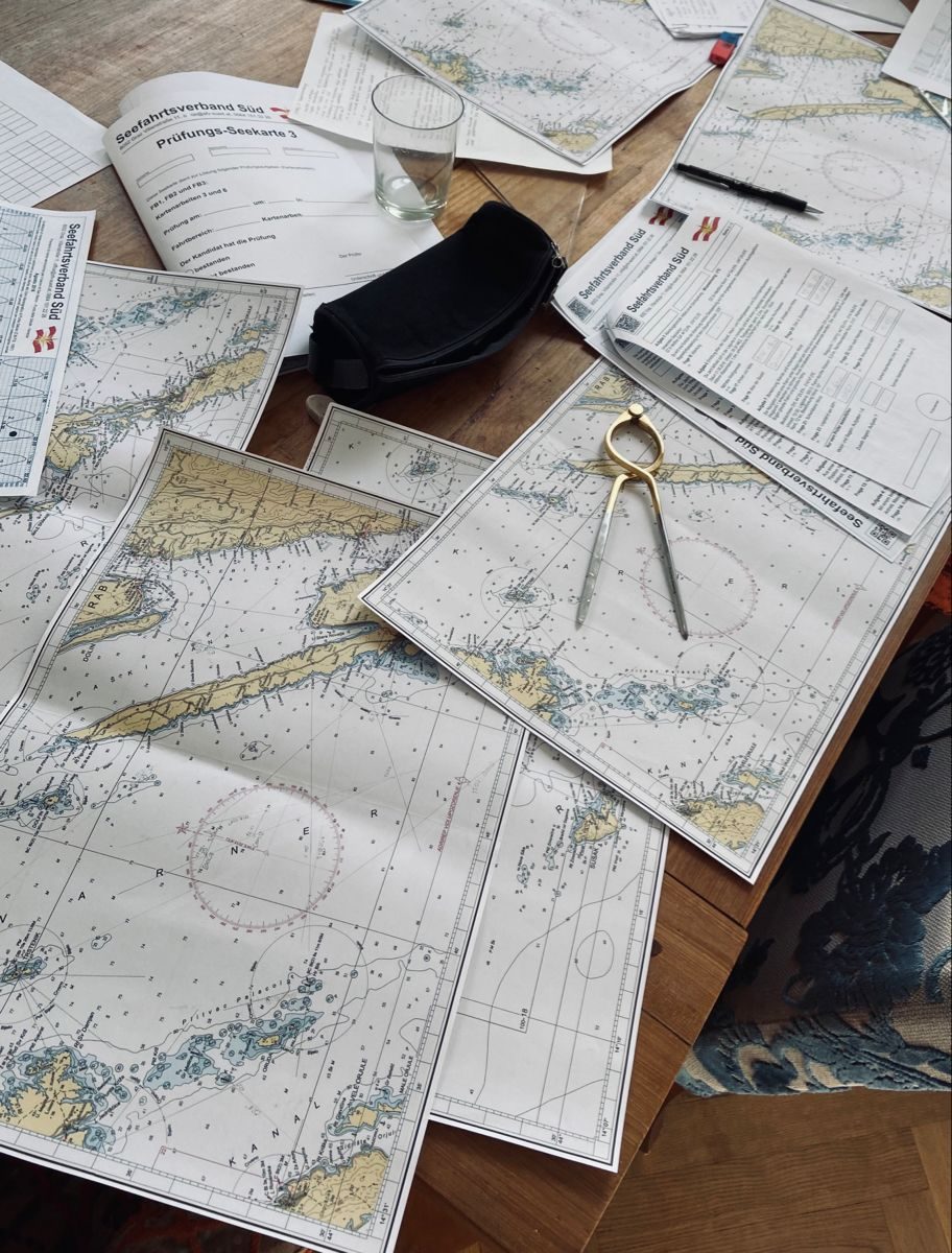 Nautical charts and navigation instruments laid out for study